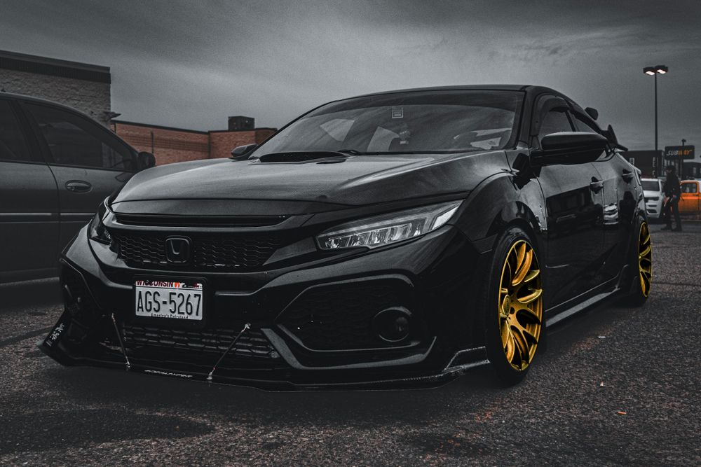 Side profile views of modified black Honda Civic Type R with custom wheels.