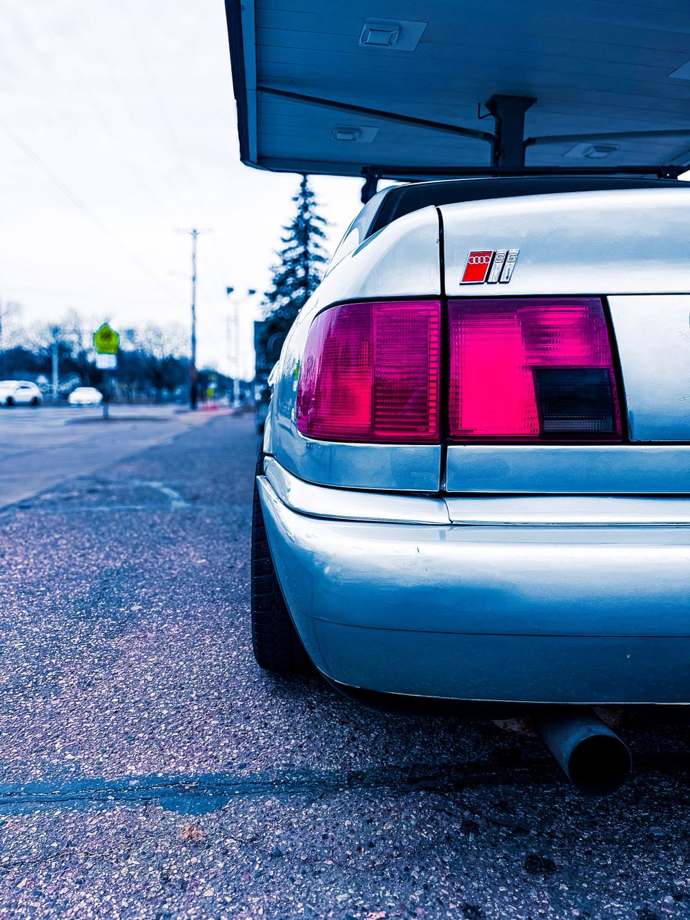Low angle shots of an Audi's rear bumper and taillights with performance styling.