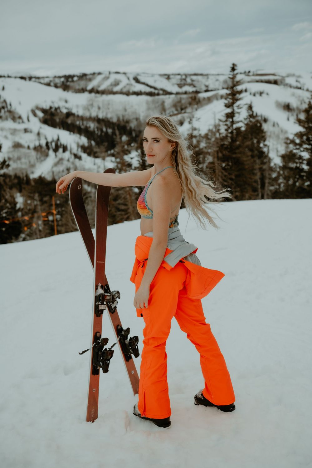 Female skiing in lingerie in Utah mountains during an outdoor boudoir photo session