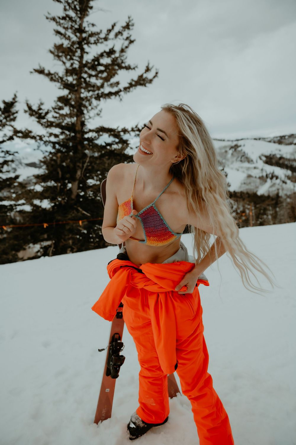 Woman skiing in lingerie in Utah mountains during an outdoor boudoir photo session