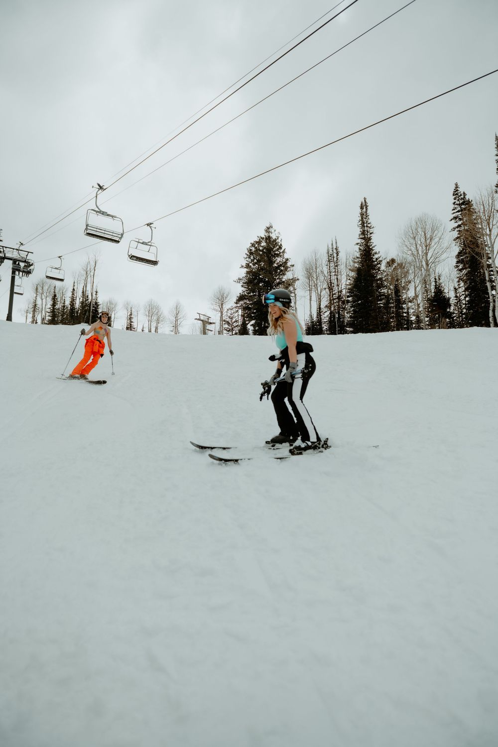 Woman skiing in lingerie in Utah mountains during an outdoor boudoir photo session