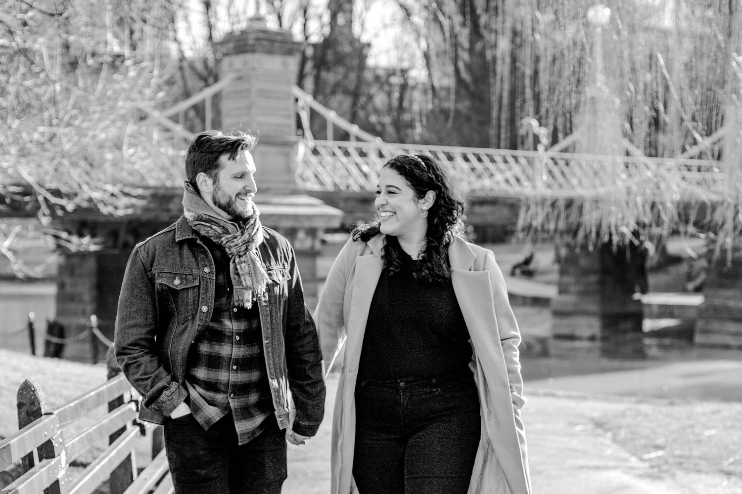 black and white candid photo of couple walking through boston public garden