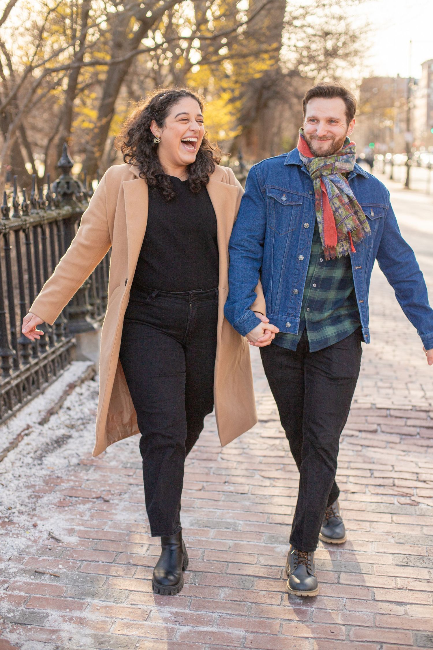 couple laughs on Beacon Street near Beacon Hill Boston Massachusetts candid photo