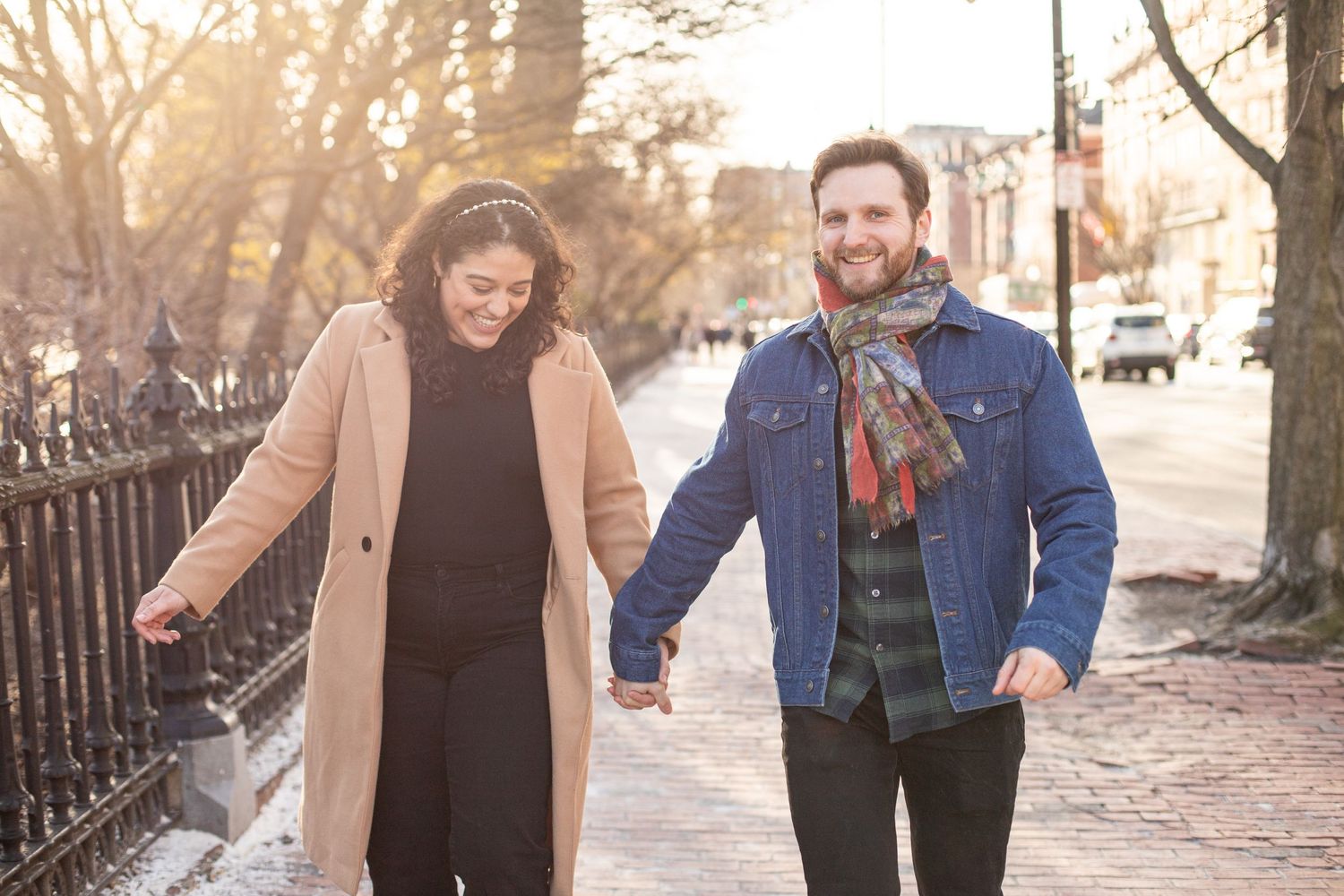 couple laughs on Beacon Street near Beacon Hill Boston Massachusetts candid photo