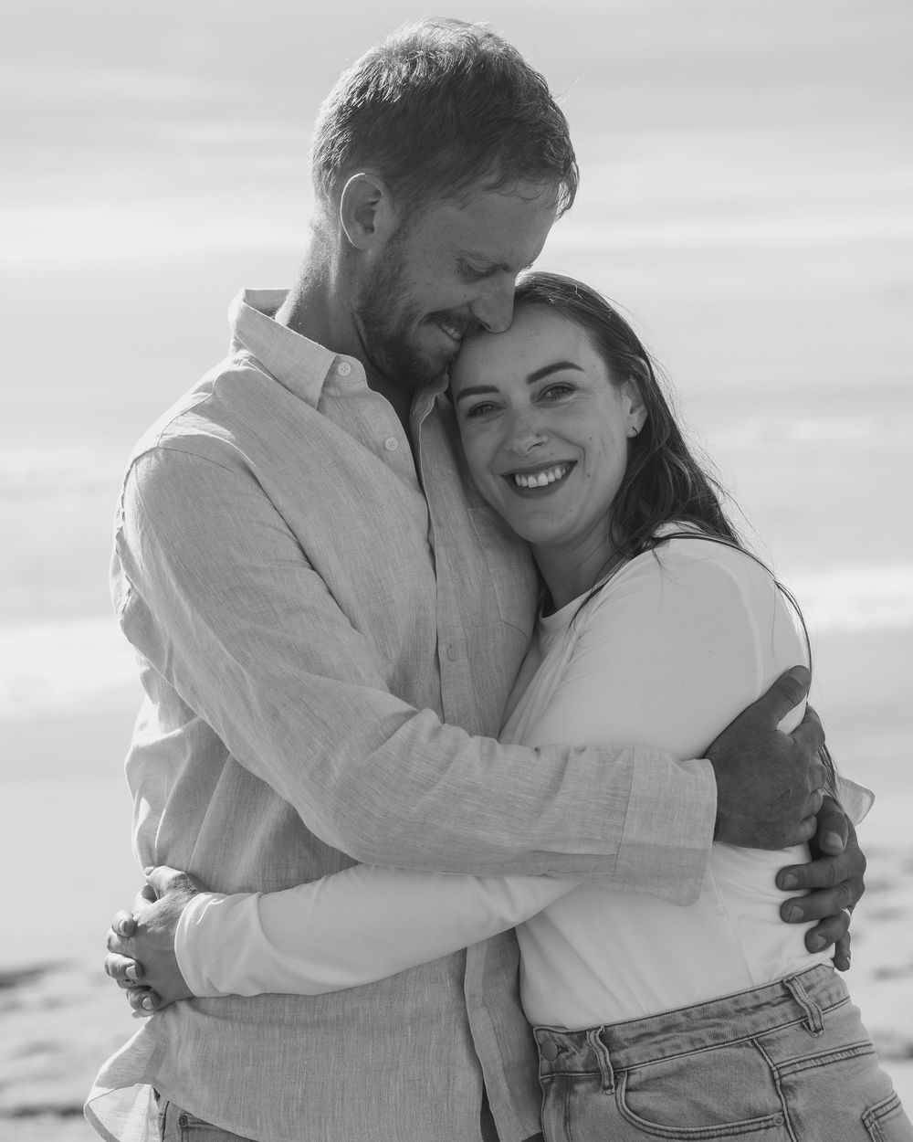 couple cuddling on the beach