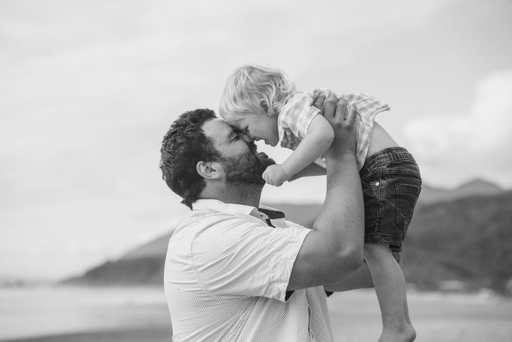 Father and son doing a hongi at Rapahoe Beach