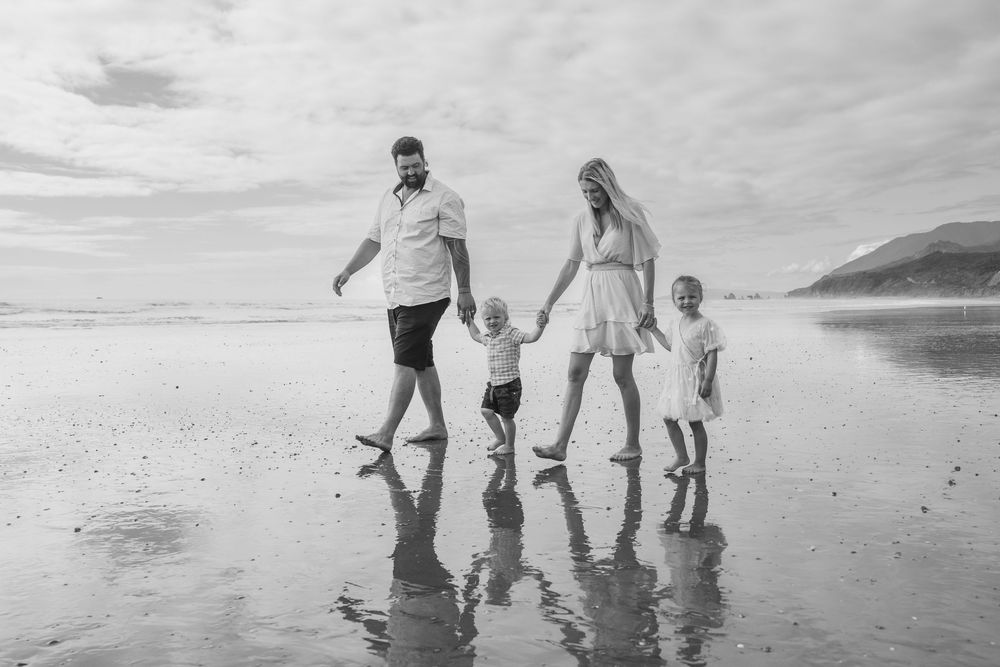Family walking holding hands at Rapahoe Beach