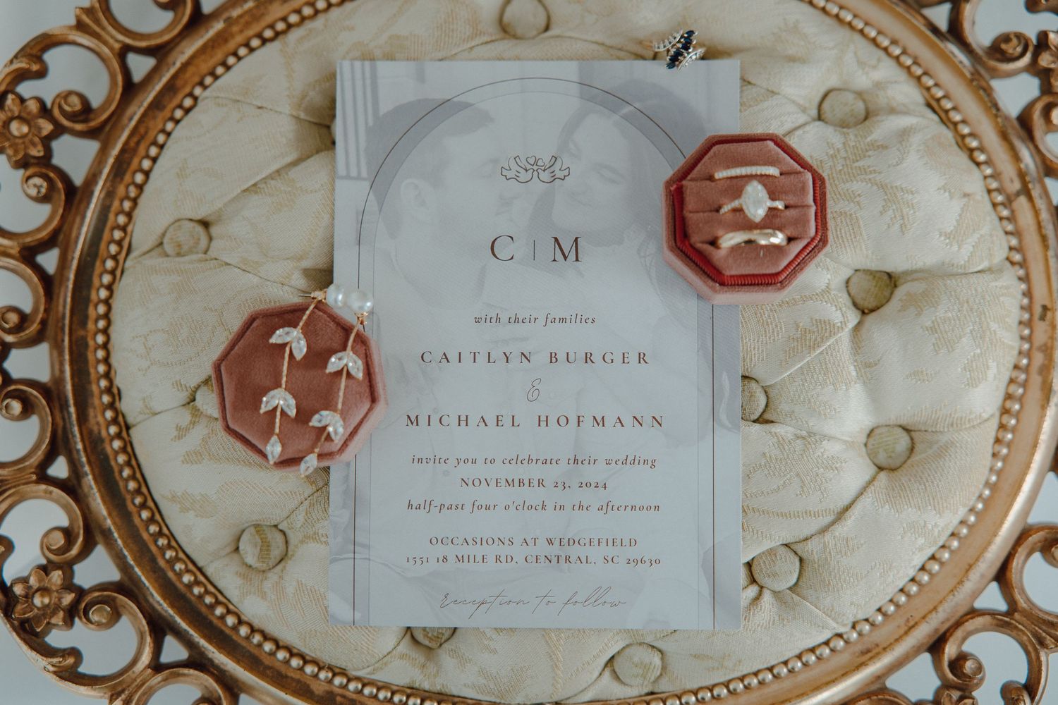 Wedding invitation suite with elegant calligraphy and wax seal on cream paper.