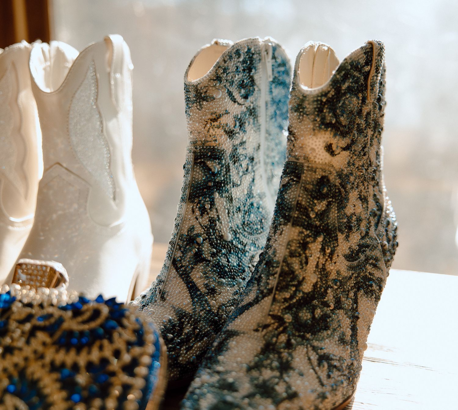 Close-up of western boots featuring white and blue floral pattern designs.