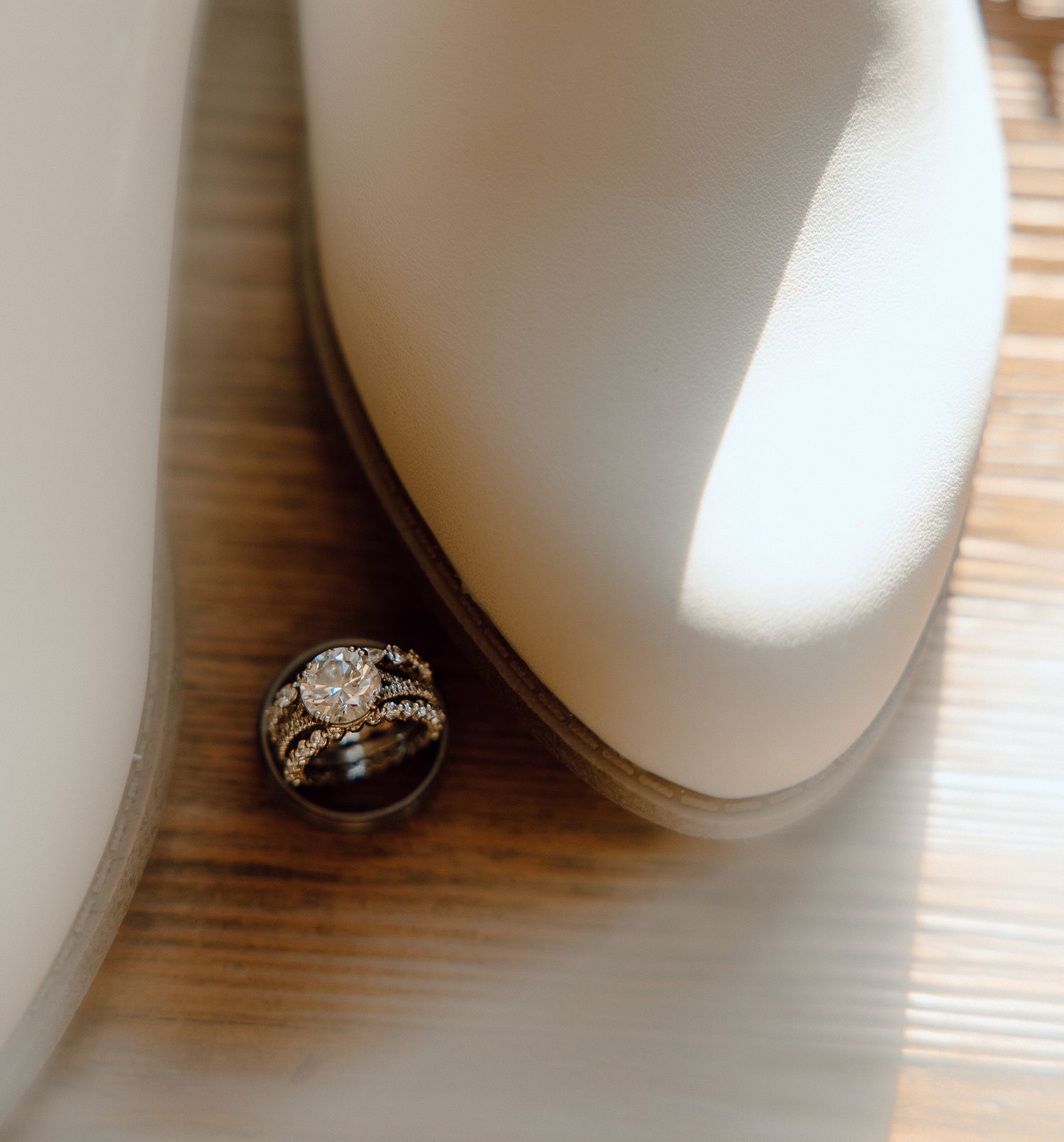 Diamond engagement ring photographed through soft white fabric creating ethereal effect.