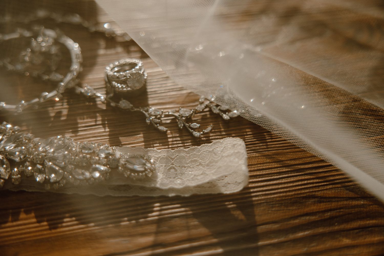 Ethereal sunlight filtering through sheer wedding veil fabric creating soft shadows.