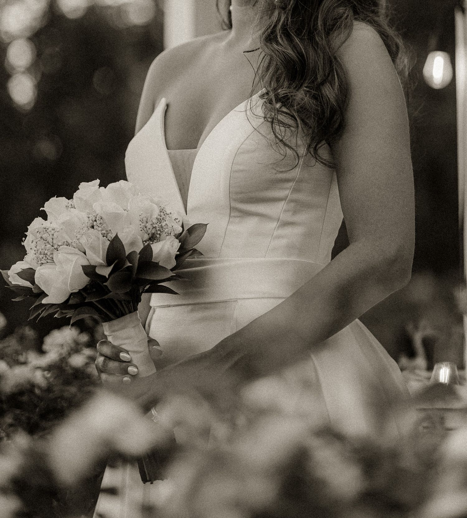 A romantic black and white wedding photo sequence showing a white dress and bouquet.