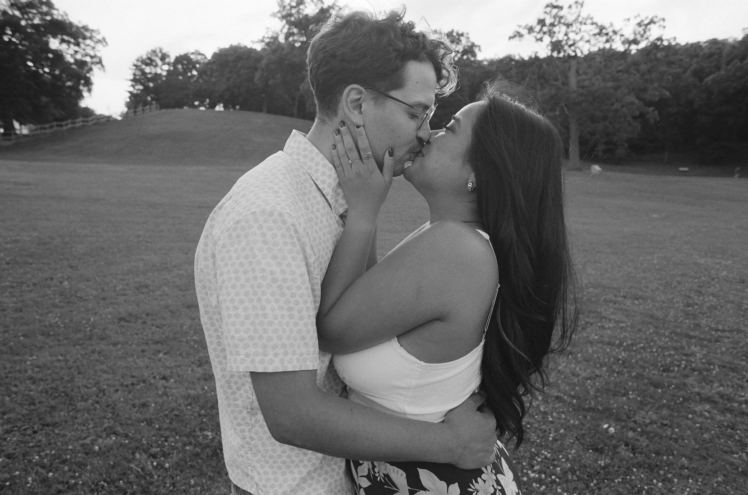 Black and white photo series capturing romantic embraces between a couple outdoors.
