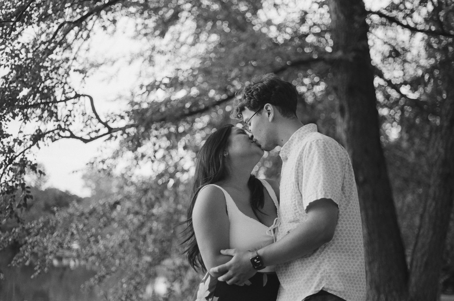 Series of candid black and white photos capturing couple's romantic interaction.