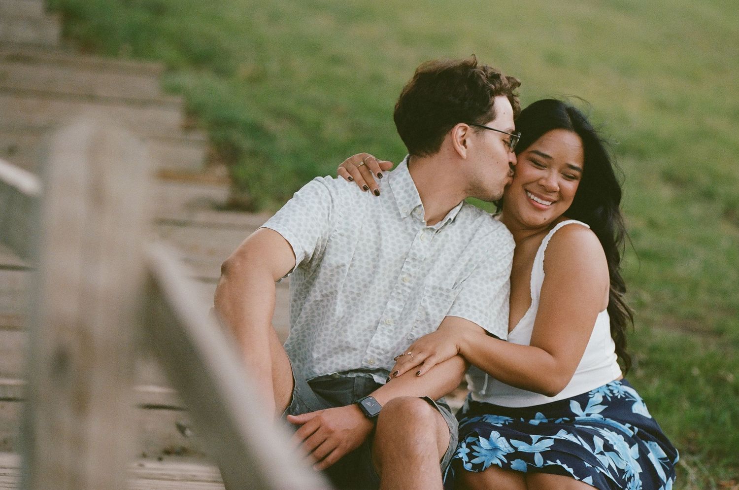 Romantic couple sharing an intimate moment while sitting outdoors.