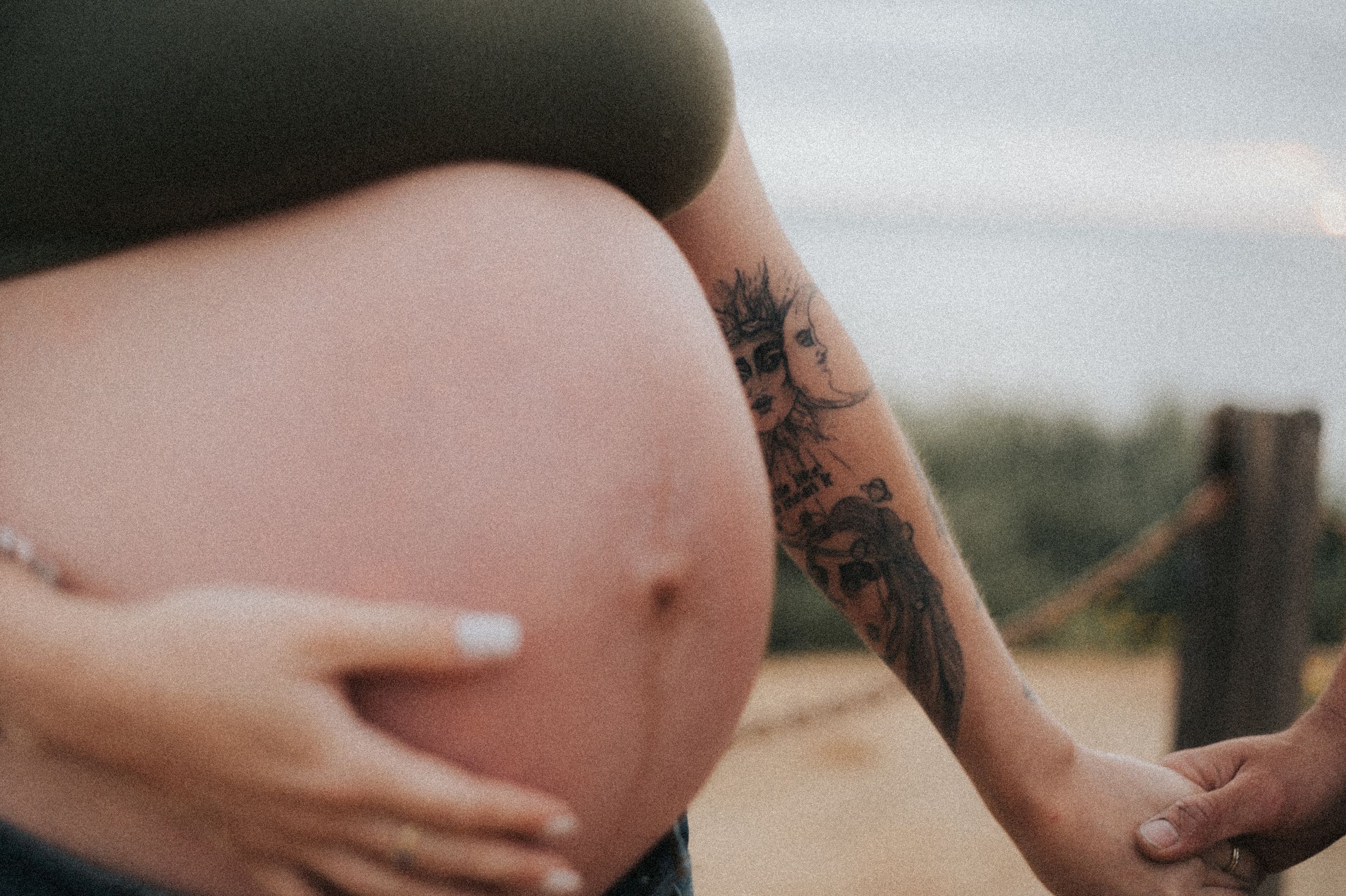 Close-up series of pregnant belly being lovingly held during coastal maternity shoot.