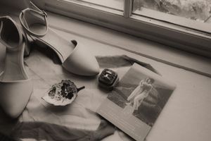 A black and white photo montage showing vintage ceramic tea cups, plates, and kitchen items arranged in a grid pattern.