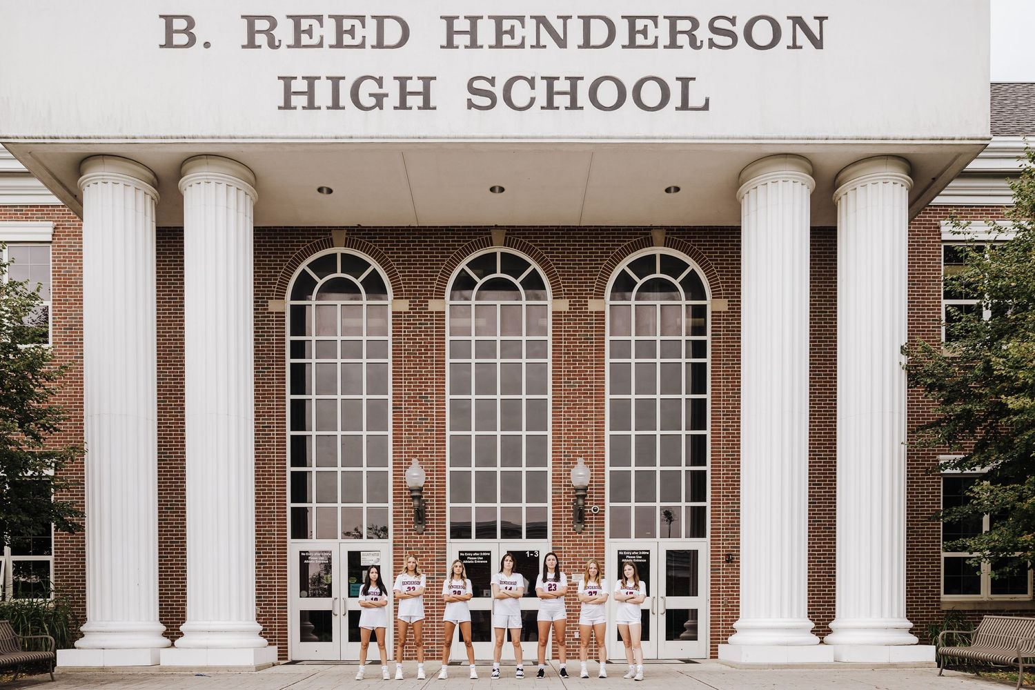 Front entrance of B. Reed Henderson High School with white columns and arched windows.