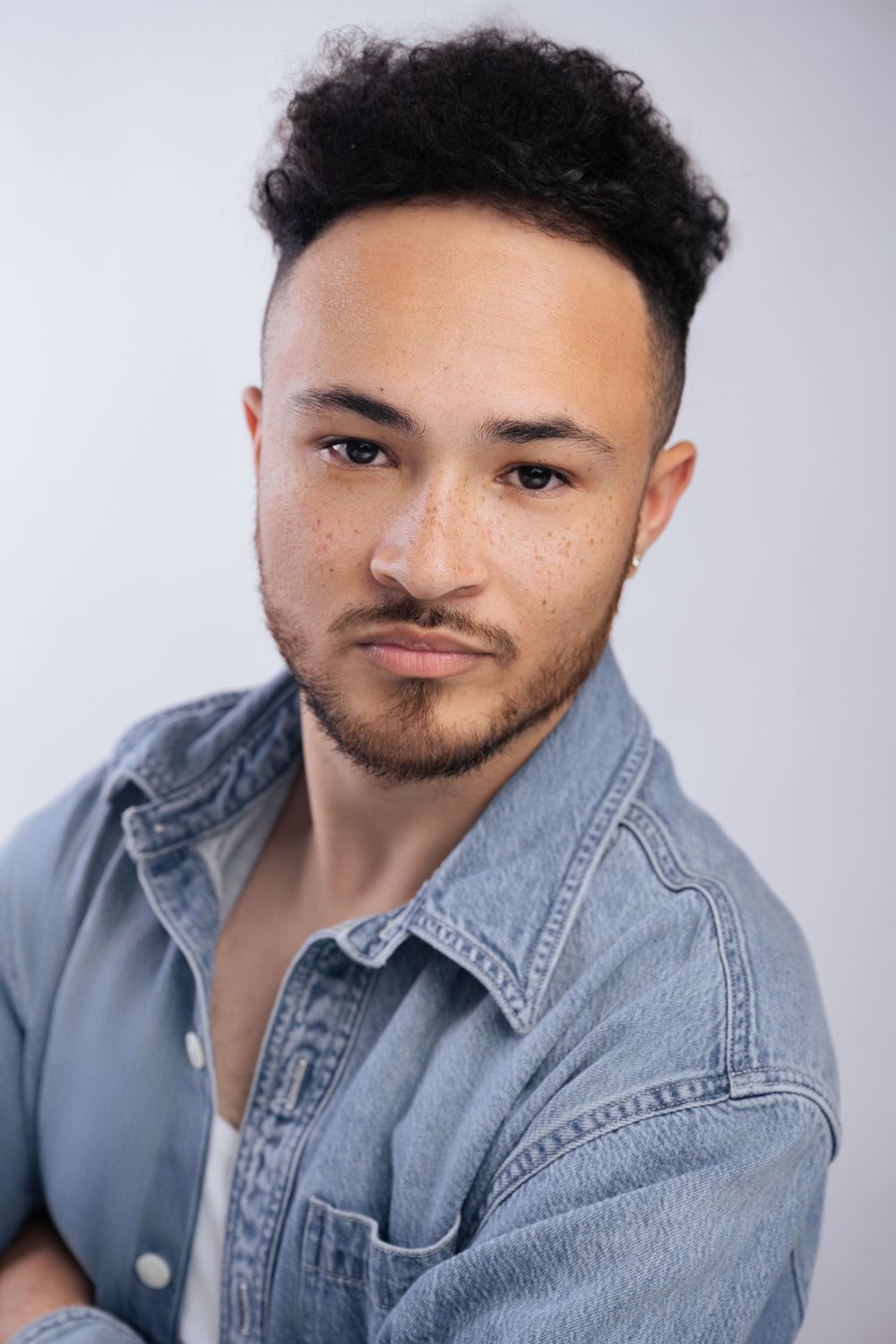 Portrait series showing someone in a light denim jacket posing against a neutral background.