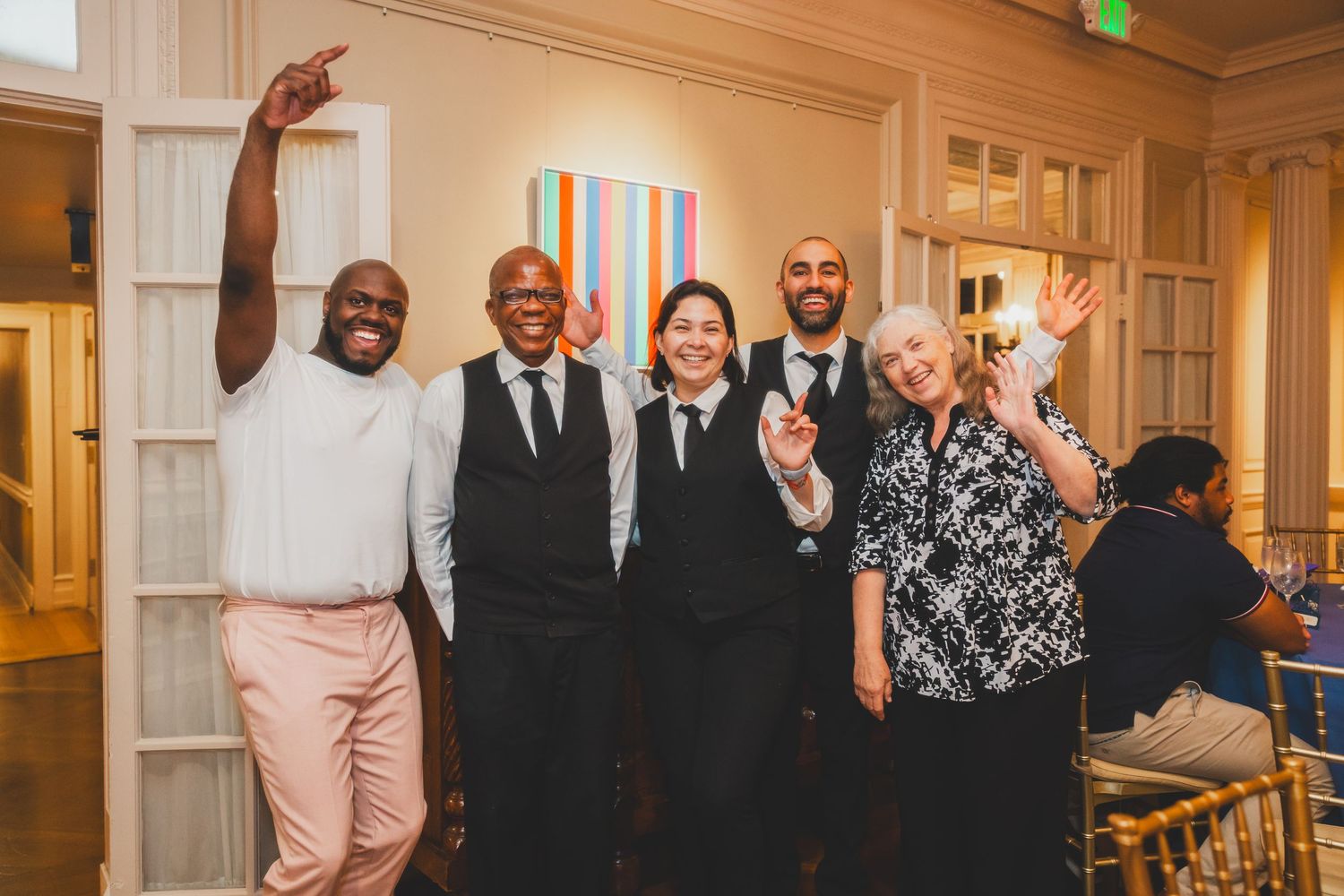 Group of event attendees celebrating together in formal attire.
