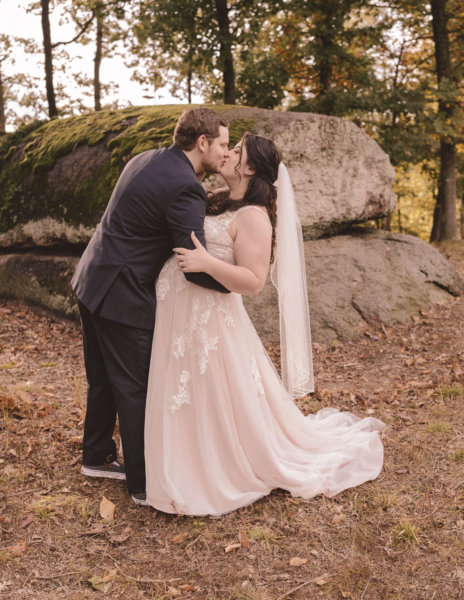 Bride and groom share a kiss on wedding day at embassy suites in Concord, NC Charlotte wedding photographers Adam and Erika