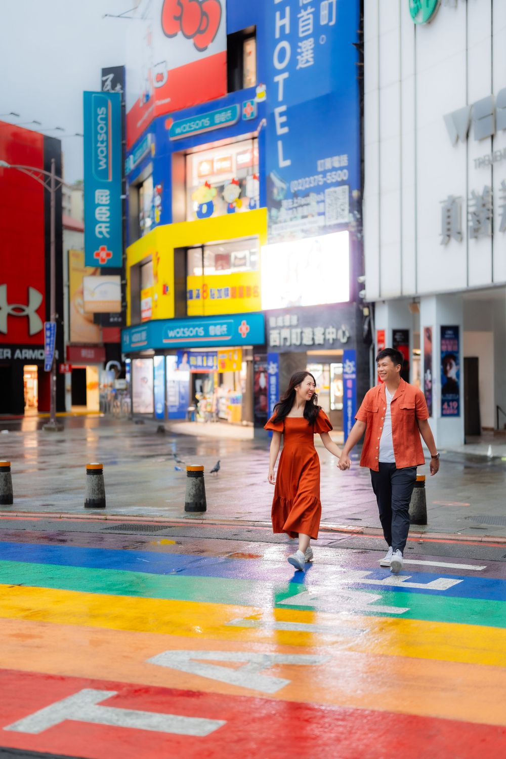a couple crossing the rainbow sidewalk in Ximending