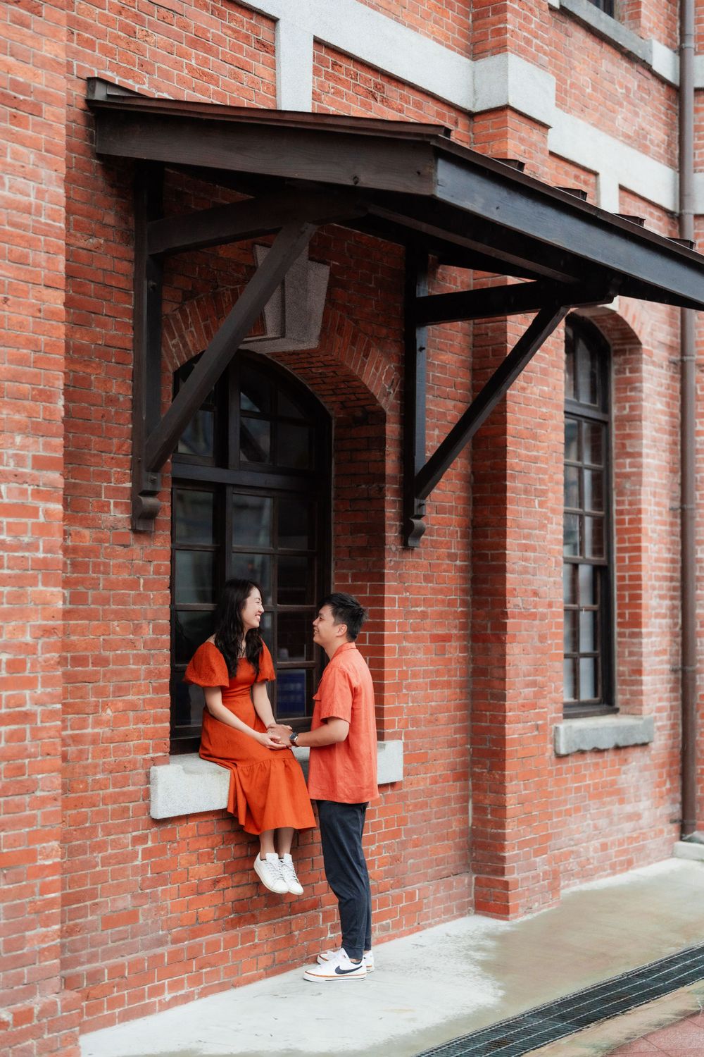 a couple and the red brick building in Ximen