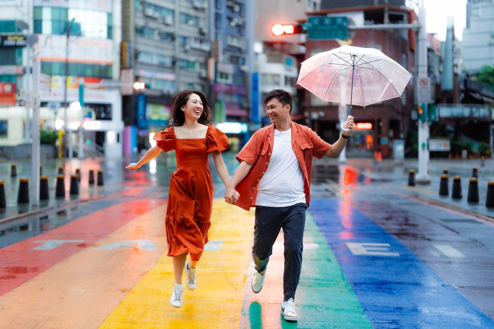 a couple running on the rainbow sidewalk in Ximending