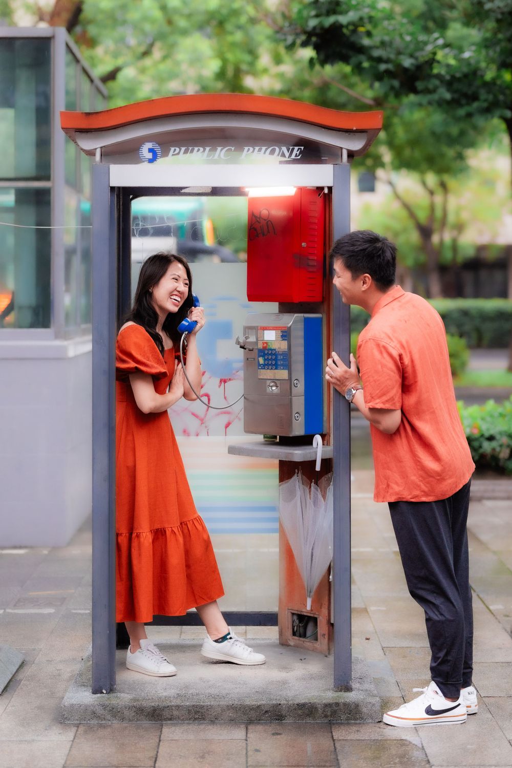 a couple and the telephone booth in Ximending