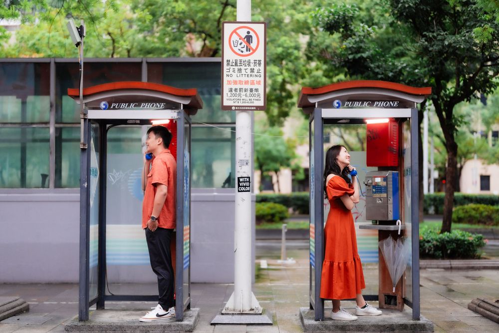 a couple and the telephone booths near Ximen Station