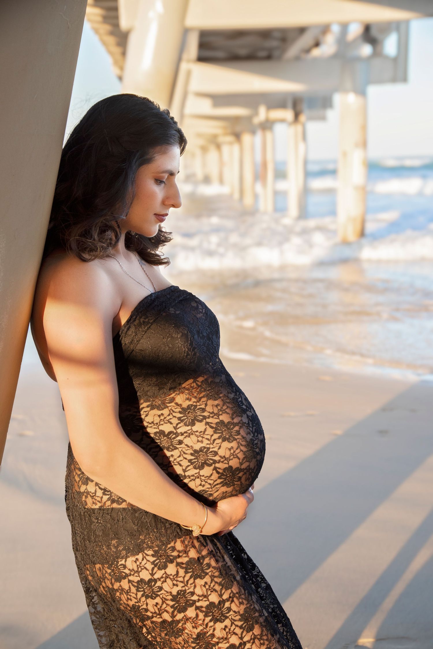 Outdoor maternity session Gold Coast beach at sunset with a stunning lace dress.
