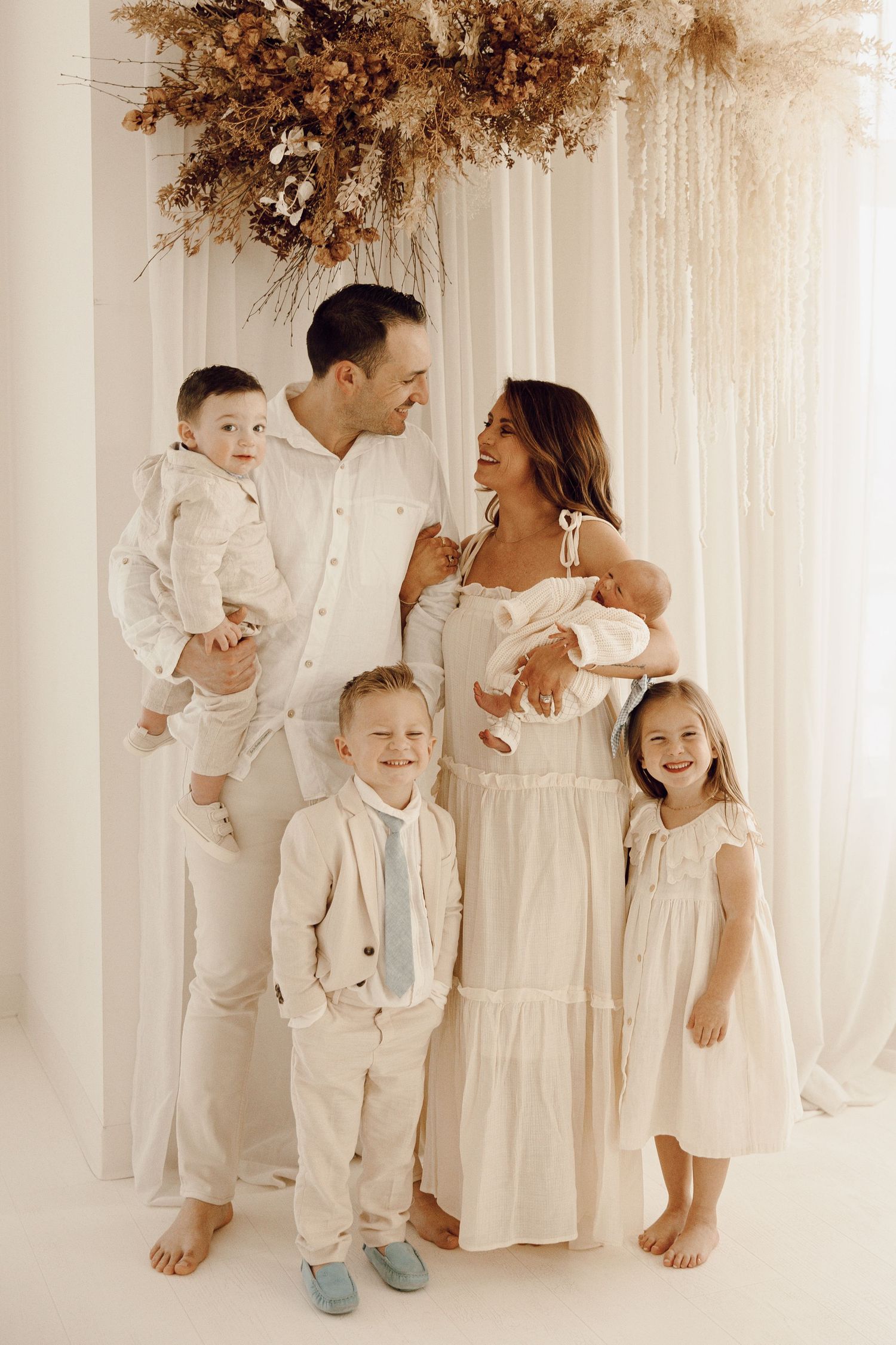 Family of five enjoying quality time together, captured in a heartfelt family photography session.