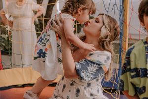 Tender moment between parent and child at festive celebration.