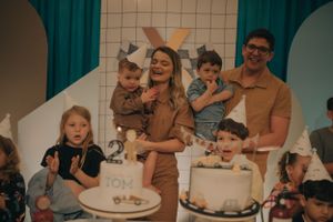A celebratory birthday party scene with cakes and decorations in turquoise and white.