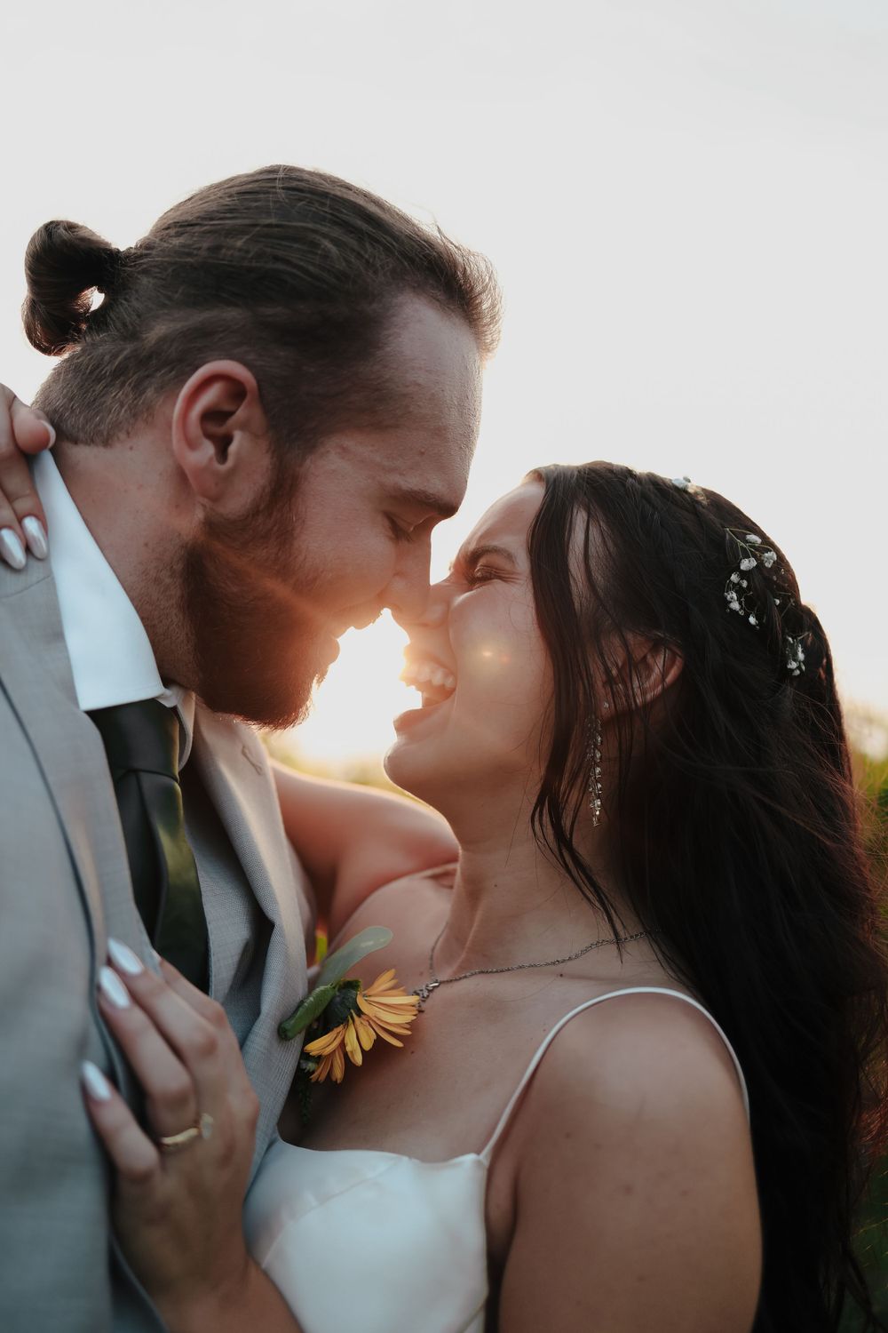 Romantic sunset wedding portrait in a natural outdoor setting.