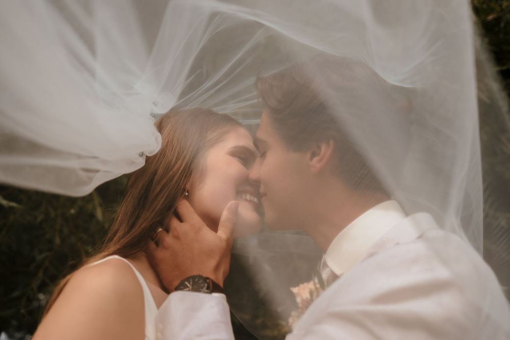 Romantic bridal veil photos capturing intimate moments in natural lighting.