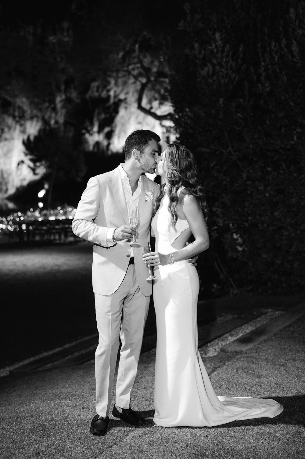 A black and white portrait of a couple sharing an intimate moment at their evening wedding.