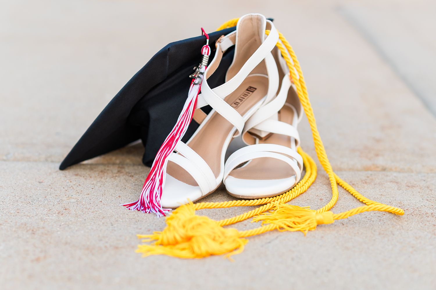Graduation cap, cords, and heels during a Heyworth, IL senior photography session by Julie Loy Photography.