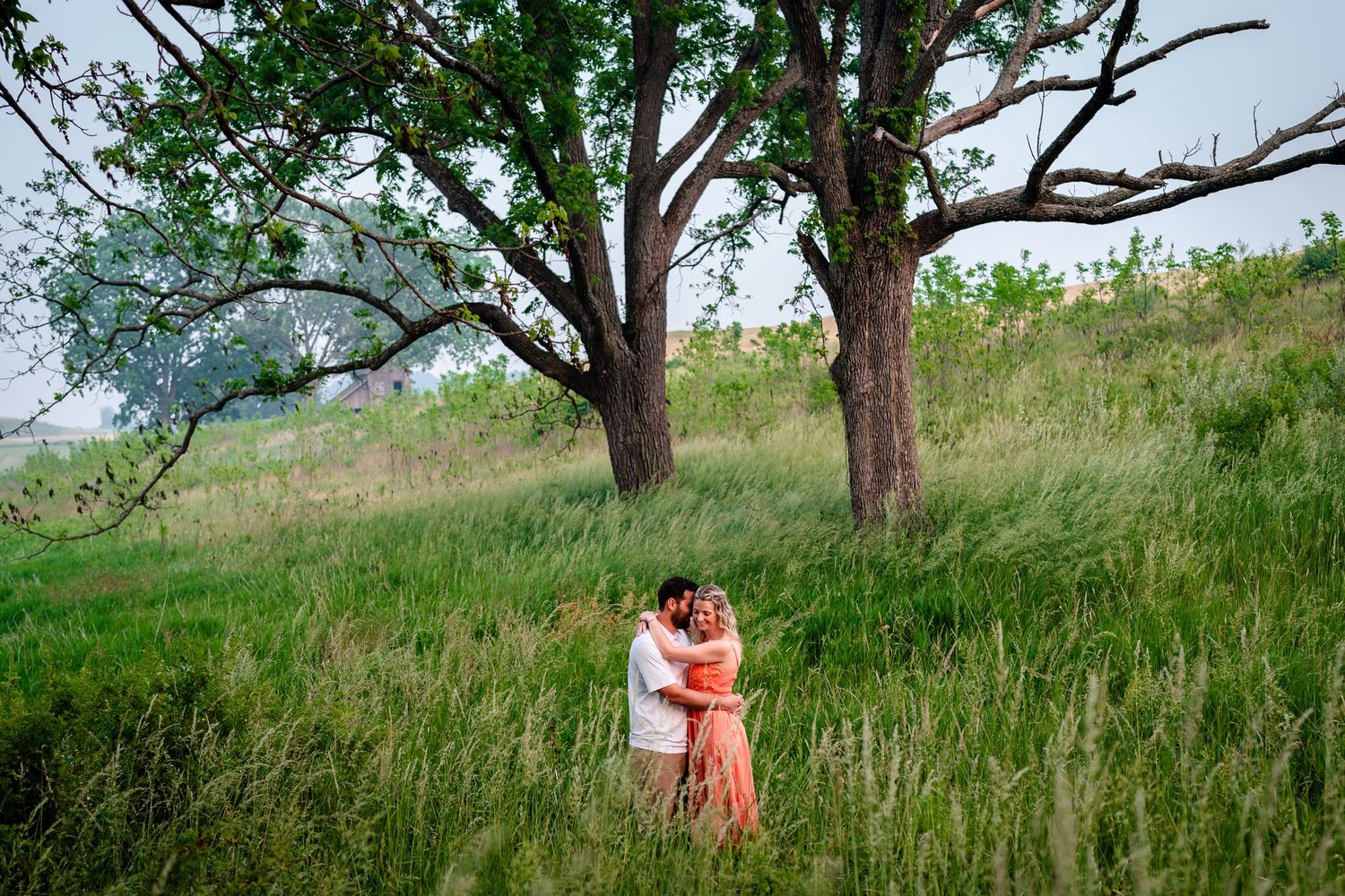 Couple embracing in the tall grass after the Jim Thorpe, PA proposal