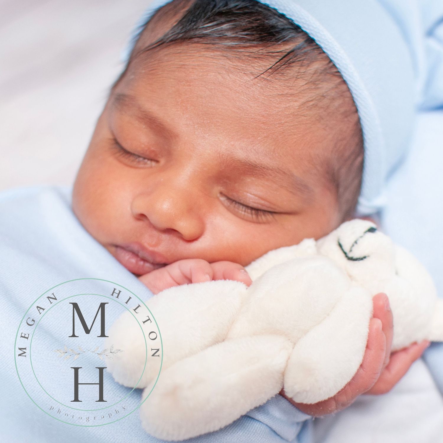photo of newborn with hat and teddy