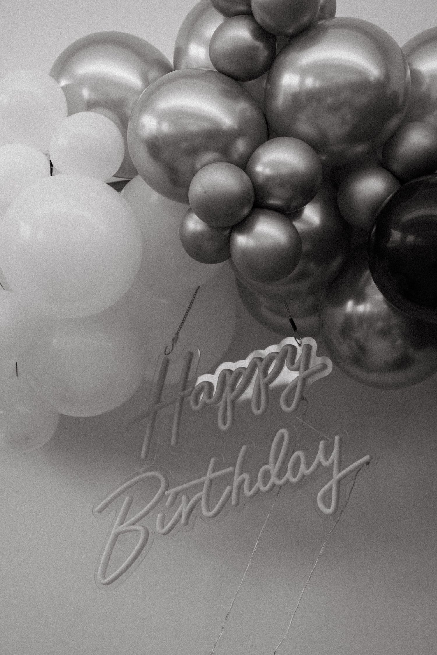 Black and white balloon arrangement with Happy Birthday text.