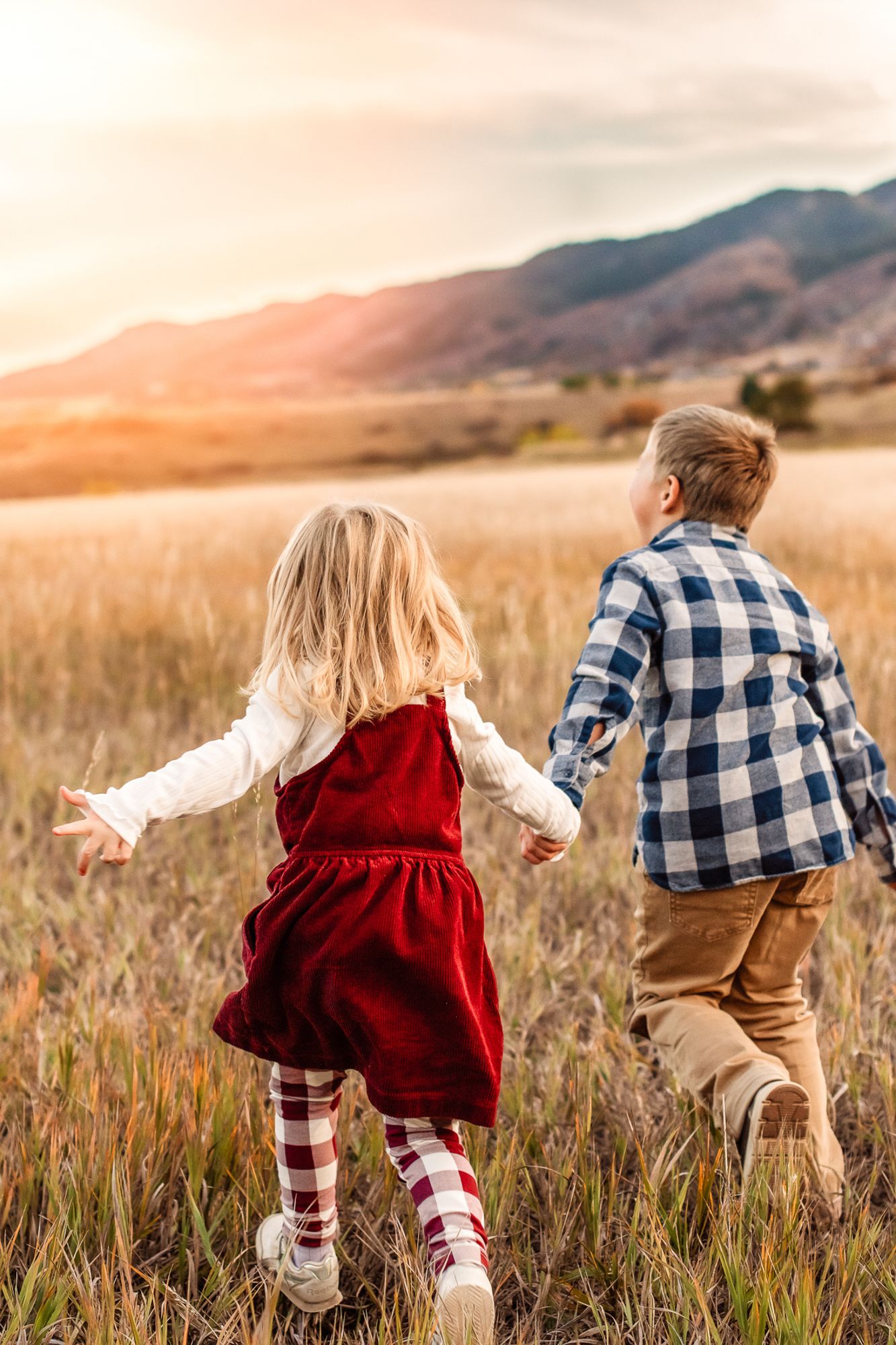 siblings holding hands running in south valley park