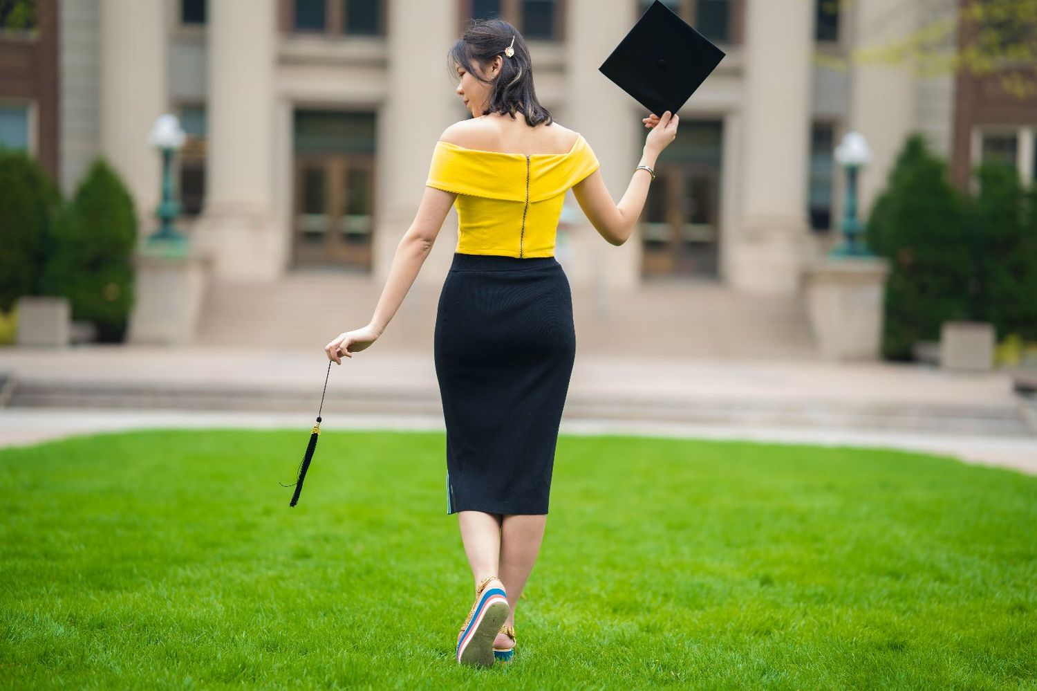 A senior poses with their graduation cap tilted playfully, expressing excitement for the future