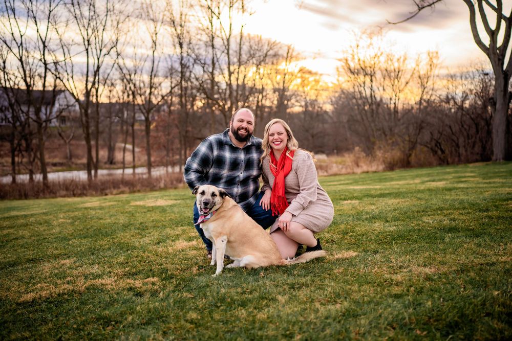 Golden hour and this gorgeous sky make for a beautiful backup for this sweet couple and their dog.