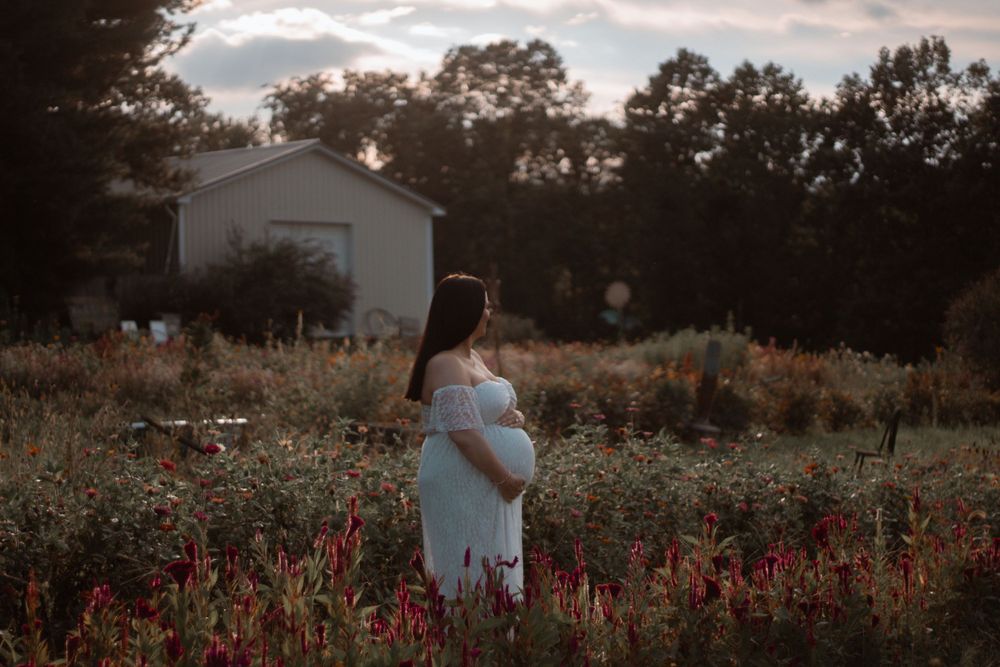 Rustic farmhouse backdrop with wildflower field at dusk.