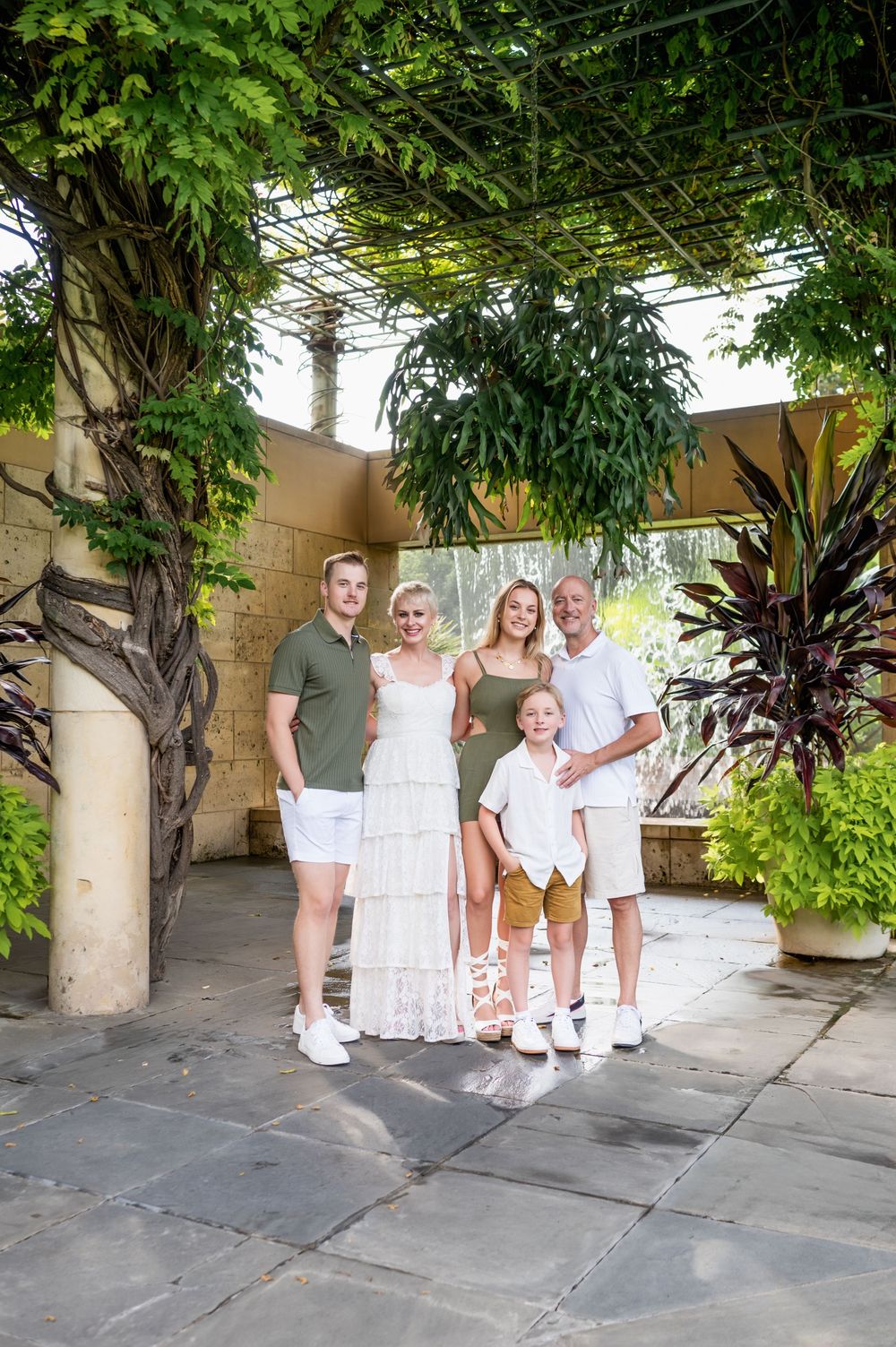 Family of 5 poses together during family photos at the Dallas Arboretum by mesquite, tx family photographer