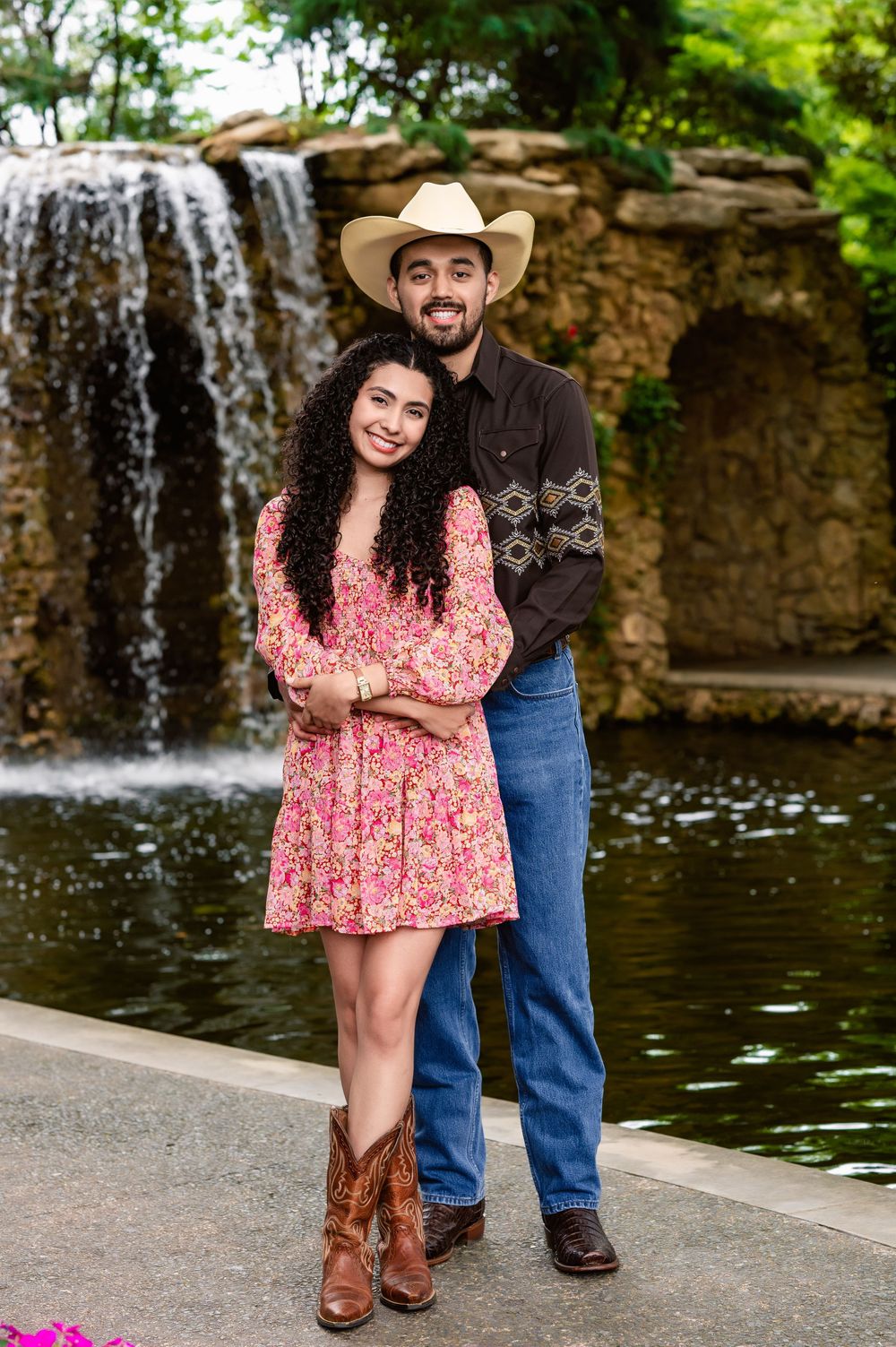 Newly engaged couple poses together at the Dallas Arboretum during couples photo session by Mesquite, tx family photographer