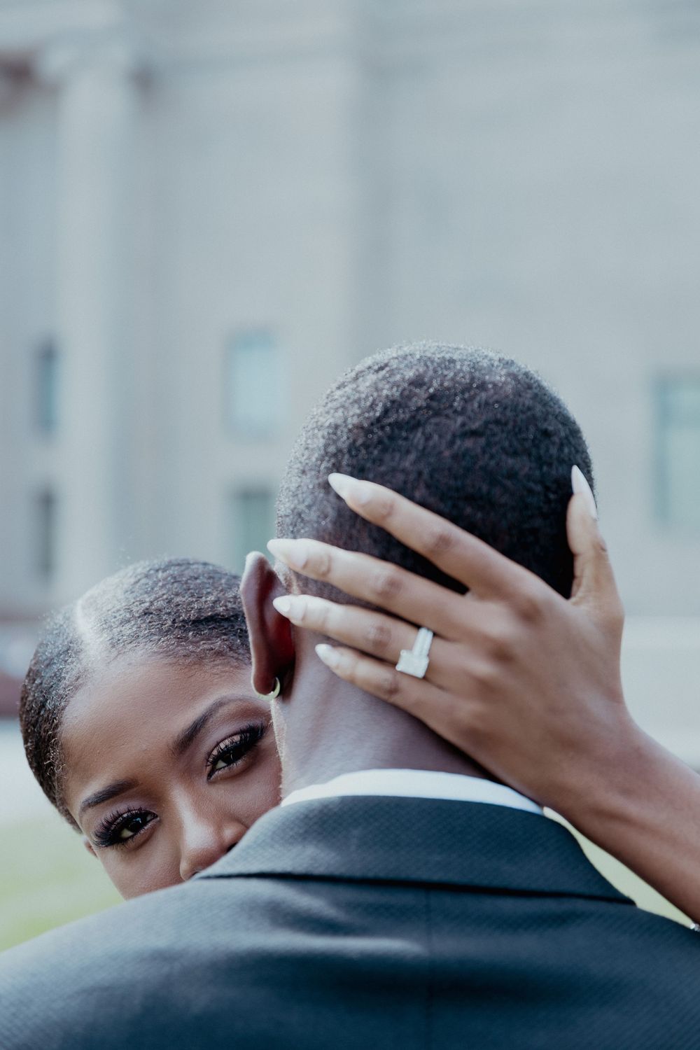 Close-up shots of an intimate embrace between a couple showing hands and shoulders.