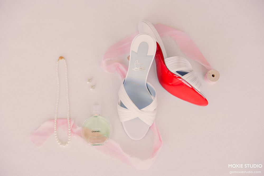 Pink and white ballet shoes arranged in an artistic composition against a light background.