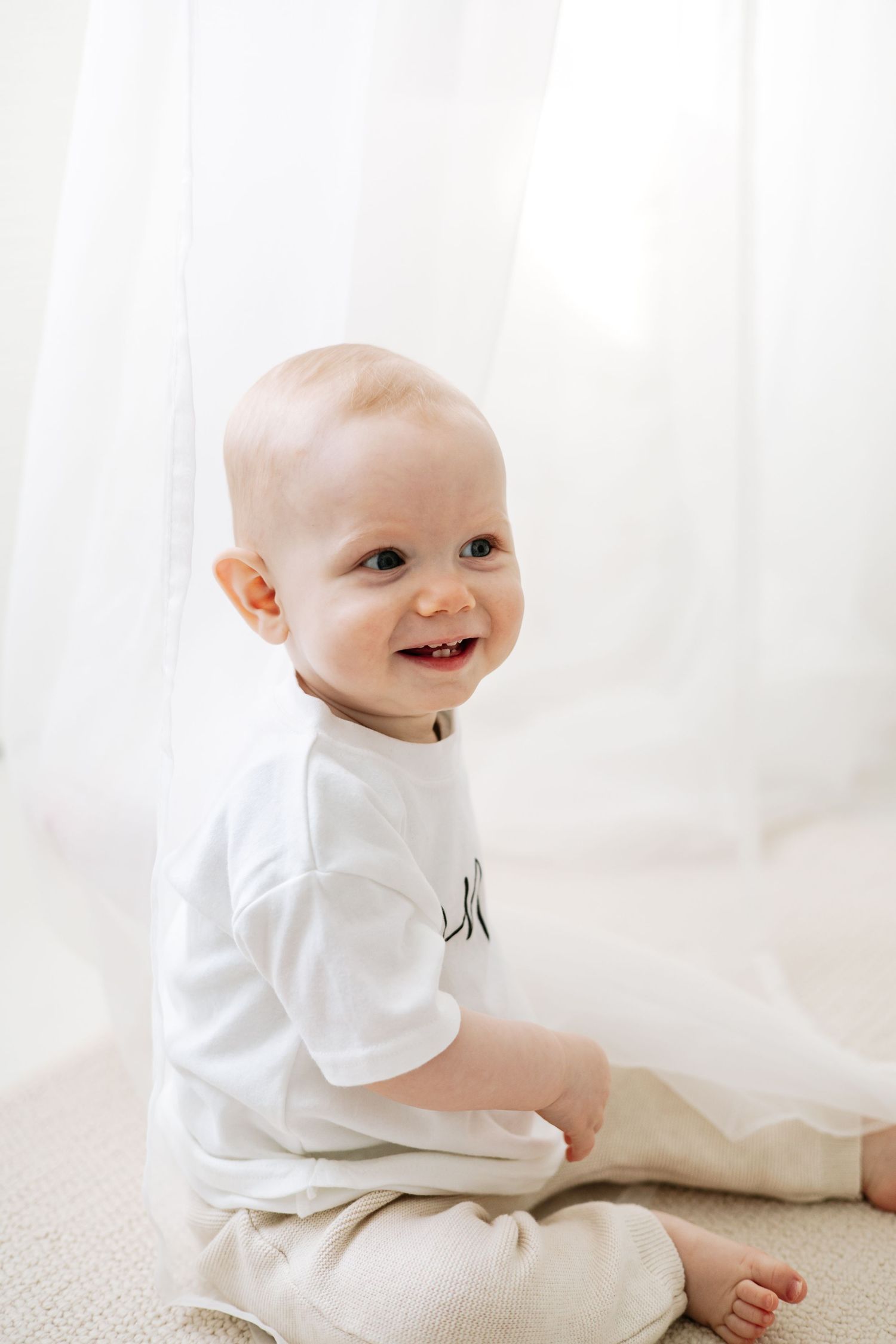 First birthday photography Nottingham baby milestone session in cosy studio, Baby smiling